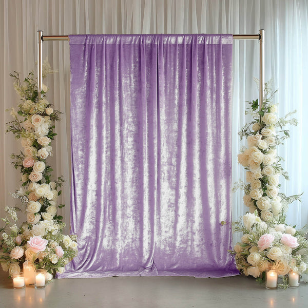 Lavender shimmer wedding backdrop with floral arrangements and candles