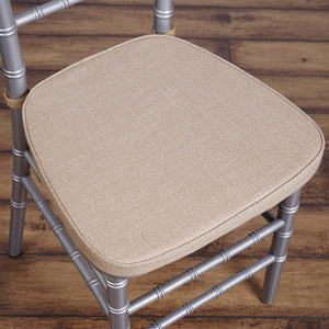 Silver chiavari chair with a beige cushioned seat.
