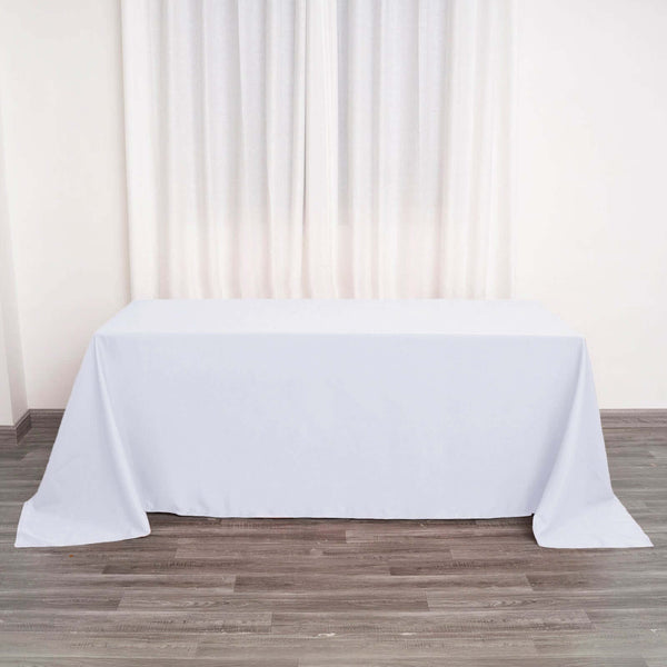 White tablecloth draped over a table in a bright, minimalist setting.