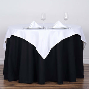 Table set with white and black linens, glasses, and napkins for an elegant dining experience.