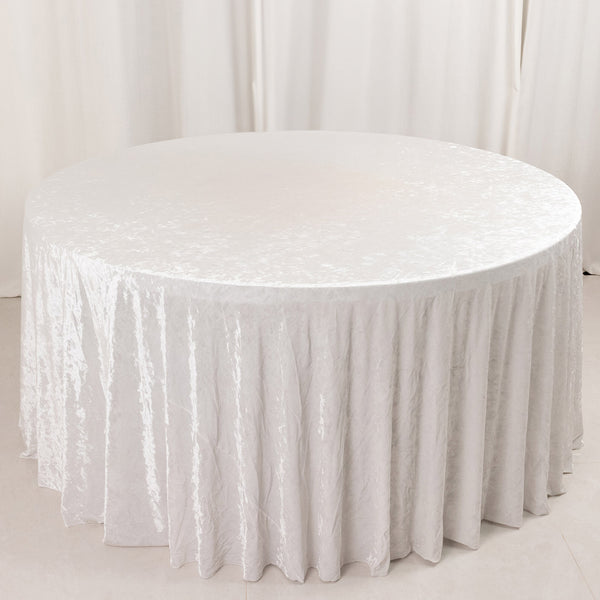 Round table with white velvet tablecloth in elegant minimalist setting