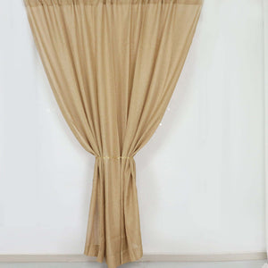 Golden sheer curtain draped elegantly on a plain backdrop.