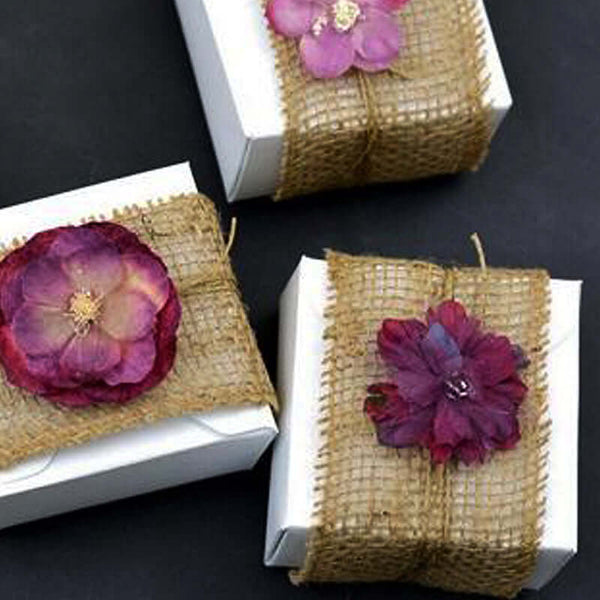 Decorative gift boxes with dried flowers and burlap accents.