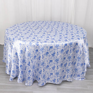 Round floral tablecloth in blue and white on a light wooden surface.