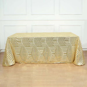 Gold geometric tablecloth with shimmering design on a table.