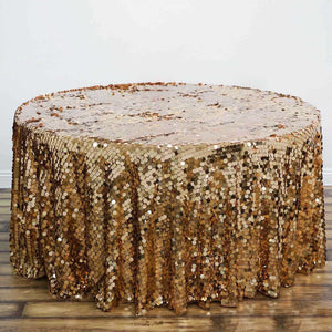 Gold sequin tablecloth draping over a round table.