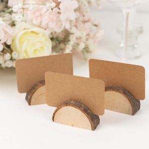 Wooden card holders with blank kraft cards for table settings.