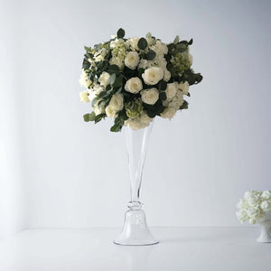 Elegant white rose bouquet in a clear glass vase.
