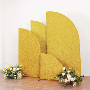 Gold glitter backdrop with decorative floral arrangements.