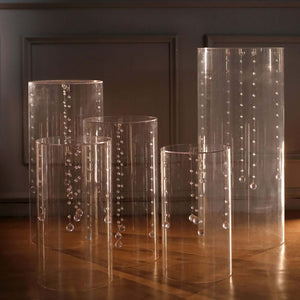 Clear acrylic vases with suspended beads in various heights