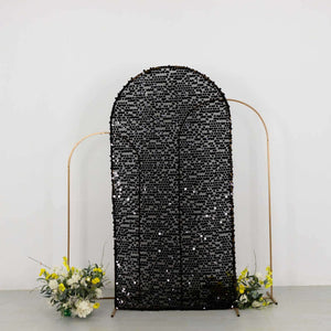 Black sequin backdrop with gold frame and floral accents.