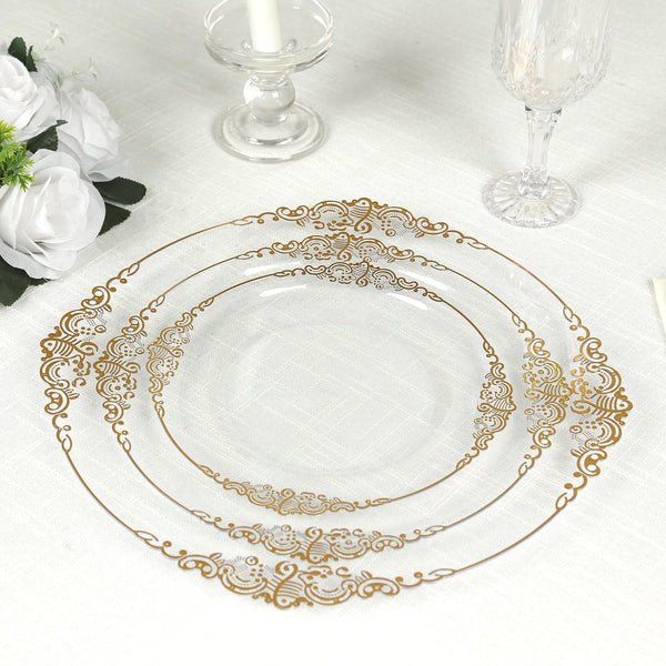 Elegant gold-trimmed glass plates set on a table with white floral decor.
