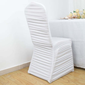 White chair cover with pleated design against a plain backdrop.