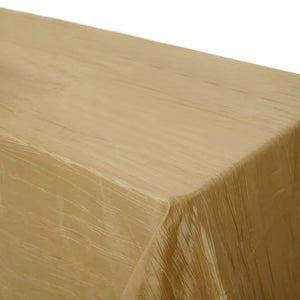 Gold tablecloth with a glossy finish on a plain background.