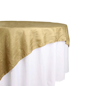 Gold tablecloth draped over a white table