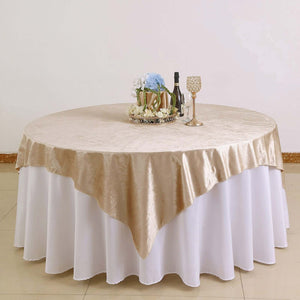 Elegant round table with gold and white tablecloth, perfect for events and dining.