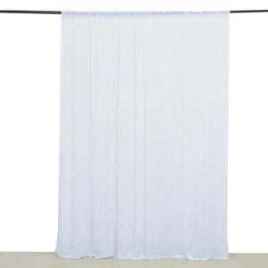 Sheer white curtain panel hanging on a rod