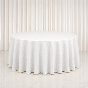 White round table with textured linen tablecloth in elegant neutral room