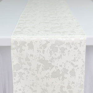 White textured fabric runner with subtle abstract pattern on a table