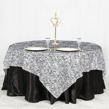 Elevate Your Jungle Theme Party with the Black and White Tiger Print Taffeta Square Table Overlay