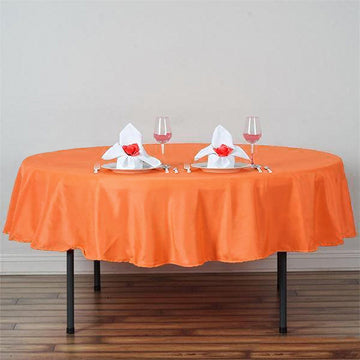 Add a Pop of Color to Your Event with an Orange Seamless Polyester Round Tablecloth 90"