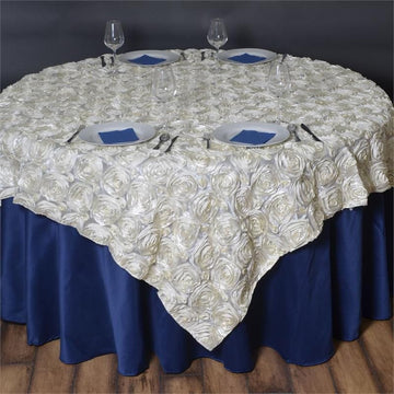 Elevate Your Event Decor with the Ivory 3D Rosette Satin Square Table Overlay