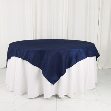 Elevate Your Event with the Navy Blue Accordion Crinkle Taffeta Table Overlay