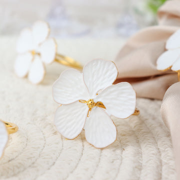 Elevate Your Table Decor with White and Gold Metal Flower Napkin Rings