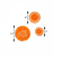 Three coral/orange paper flowers with measurements on a white background