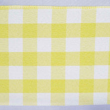 A close up of polyester chair sashes in a yellow and white checkered pattern
