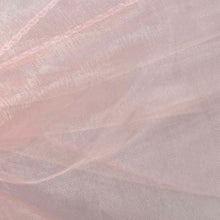 A close up of a piece of pink shimmering organza fabric