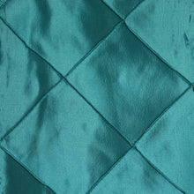 A close up of teal quilted fabric satin & taffeta chair sashes