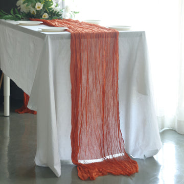 Add a Touch of Bohemian Elegance with the 10ft Terracotta (Rust) Gauze Cheesecloth Boho Table Runner
