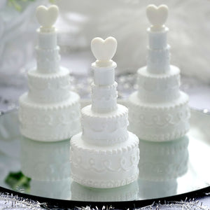 Miniature white wedding cake decorations with heart toppers. #whtbkgd