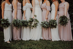 Bride standing with the bridesmaids holding bouquets