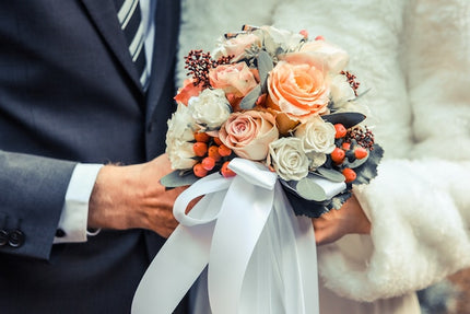 Bride and groom holding a bouquet
