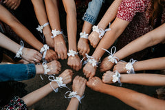 Women with ribbon bracelets in a bachelorette party