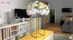 Elegant wedding floral centerpiece on a gold stand