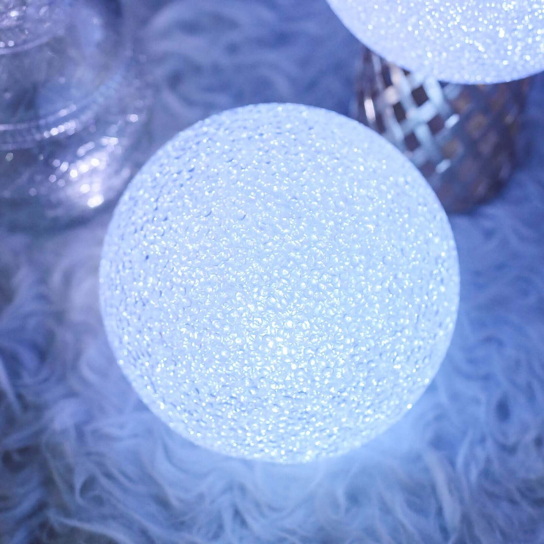 Glowing decorative sphere with a textured surface.