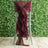 Burgundy chair sash with ruffles, elegantly draped on a silver chair.