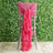 Pink chair sash with ruffled design, perfect for event decor.
