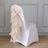 White chair with a beige ruffled sash tied at the back.
