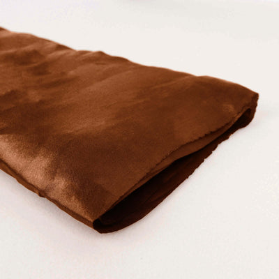 Brown satin fabric folded neatly on a white background.