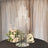 Elegant glass candle holder centerpiece with floral arrangement.
