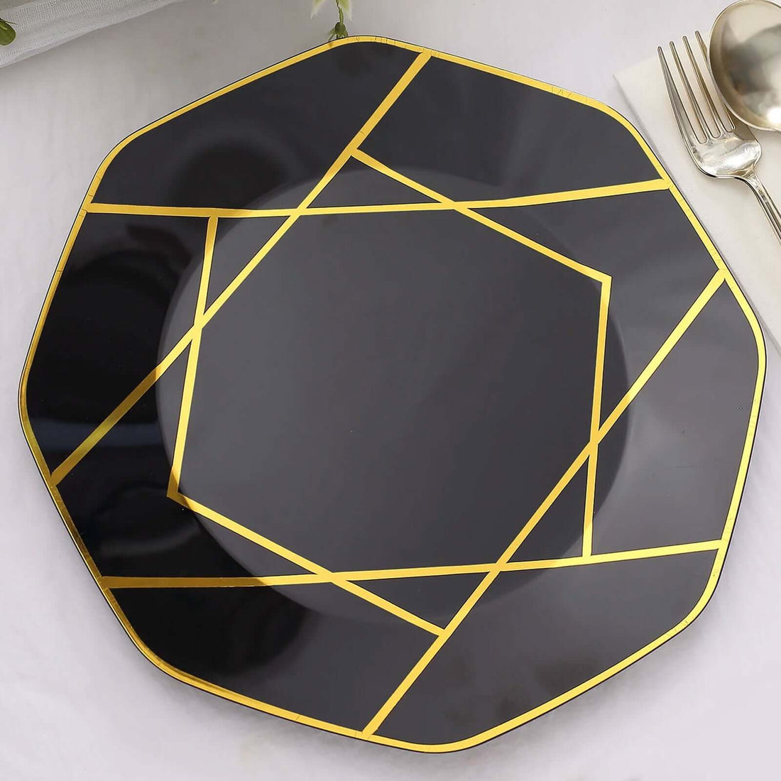 Black octagonal plate with gold geometric design.