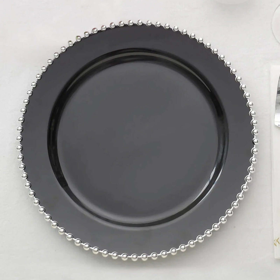Black decorative plate with pearl-like trim
