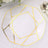 Gold geometric decorative plate on a white table setting.