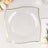 Clear square plate with gold trim on a neutral background.