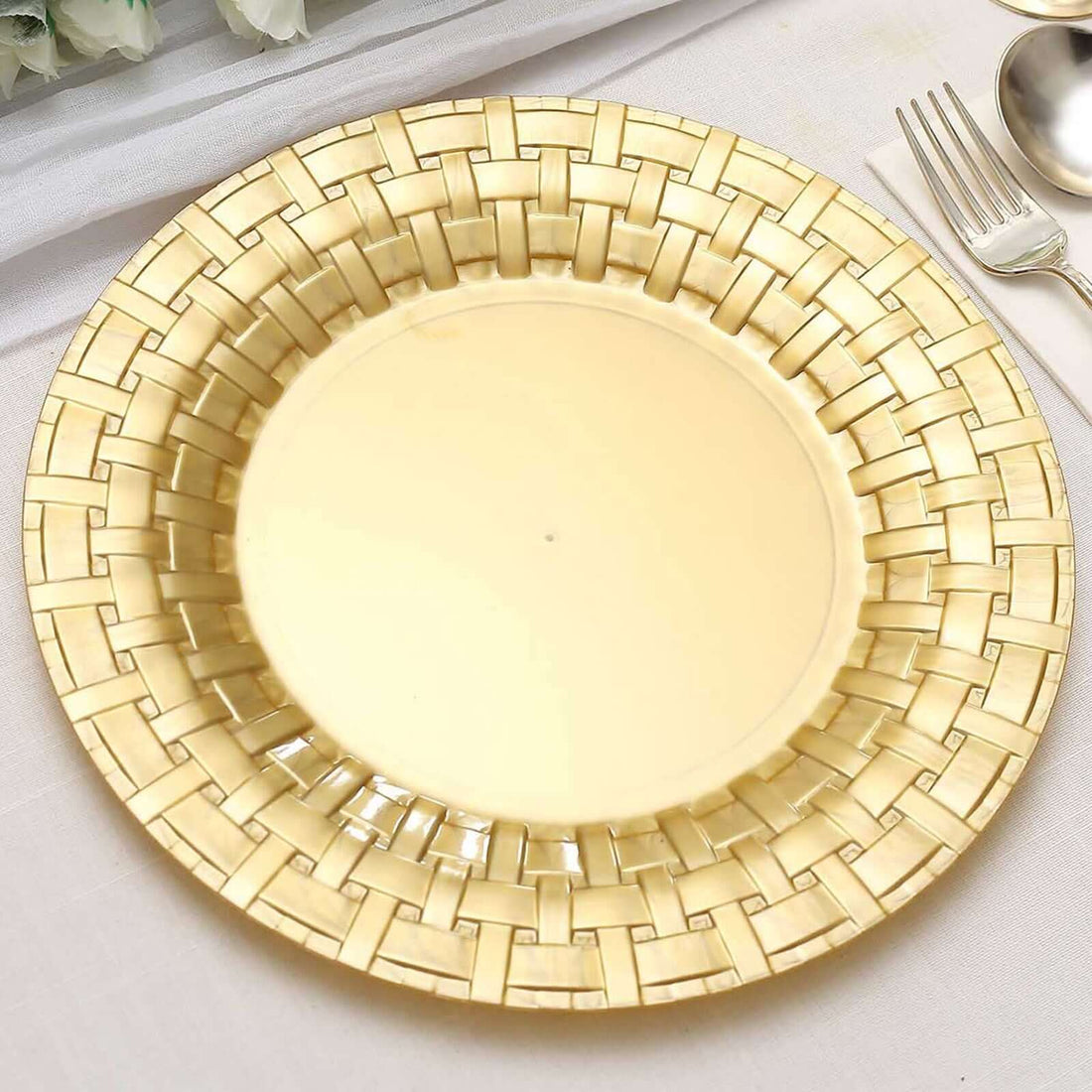 Gold decorative plate with a woven design on a light background.