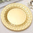 Gold decorative plate with a woven design on a light background.